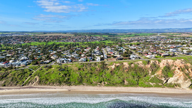Moana, South Australia &ndash; 4K aerial drone view of coastal cliffs, sandy beach, turquoise ocean, suburban homes, modern housing estates, scenic coastline and seaside landscapes in South Adelaide