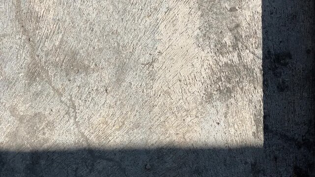 Texture concrete wall of light grey color cement texture background.Grey pastel rough crack cement texture stone concrete,rock plastered stucco wall; painted flat fade background. Side view. close up.