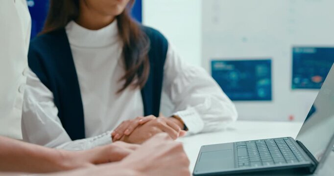 Closeup group Asian businesspeople work together discuss plan idea with investment profit sale statistics in business meeting in office. Financial generation z team brainstorm on e-Commerce project.