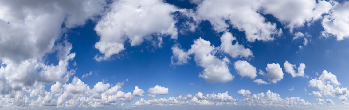Panoramic Cloudscape Sky Over British Columbia, Canada With Fluffy Cumulus Clouds And Blue Horizon