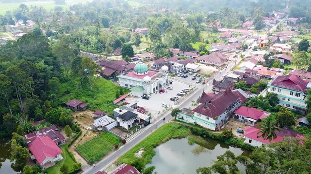 Traditional Minangkabau rumah adat and mosque with iconic curved gonjong rooftops in Magek village, West Sumatra, Indonesia