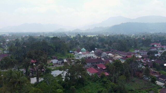 Traditional Minangkabau rumah adat and mosque with iconic curved gonjong rooftops in Magek village, West Sumatra, Indonesia