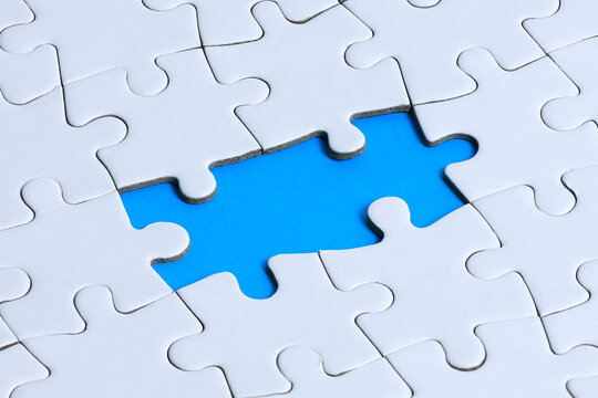 Missing Piece Puzzle Concept with Blue Gap in White Jigsaw Background