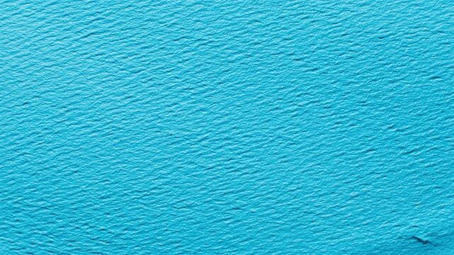 A vibrant blue textured surface with a rough, bumpy appearance and dark streaks running through it, resembling a painted or stained effect on a rough material