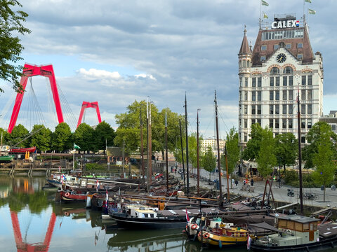 Historic Witte Huis with Willemsbrug and moored boats in Rotterdam Oude Haven under dramatic clouds, Rotterdam, Netherlands