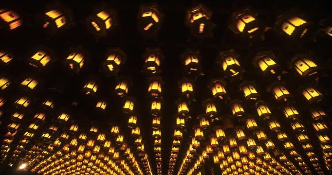 Hundreds of Glowing Hanging Lanterns on Dark Ceiling In Hiroshima Japan - low moving shot