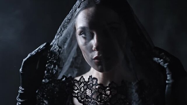 Woman wearing black gothic lace veil and velvet dress
