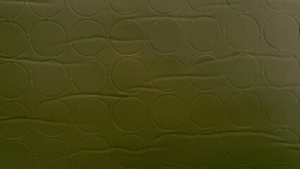 Naklejka premium olive green quilted fabric texture with geometric circle pattern background