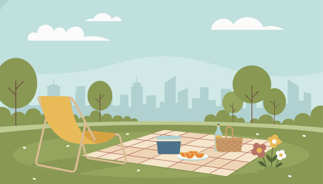 Cozy outdoor picnic setup with a folding lounge chair and a checkered blanket carrying a picnic basket, cooler, and snacks with a city skyline view.