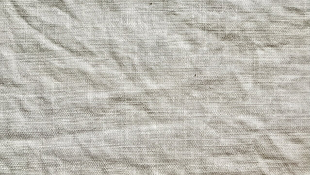 crumpled beige linen fabric texture background with organic folds and rustic neutral woven textile aesthetic