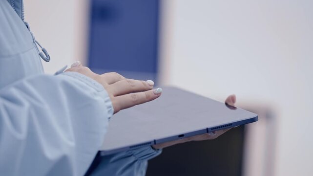 Side View Close up of Female Lighting Technician Hands Holding and Operating Digital Tablet in Studio