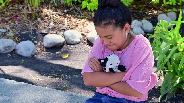Latina girl making faces at another person in the park