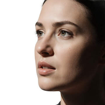 Woman face beauty portrait of a young lady with clean skin looking up isolated on a transparent background for skincare ads