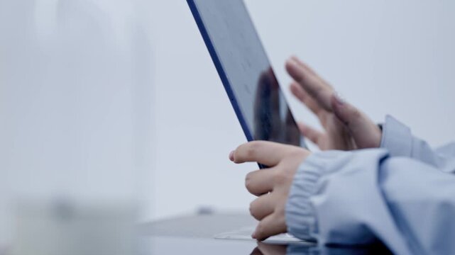 Low Angle Close up of Female Lighting Technician Hands Operating Digital Tablet on Studio Desk