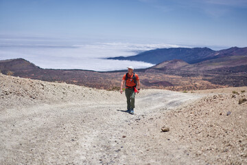 Fototapeta premium Male hiker above sea of clouds Teide
