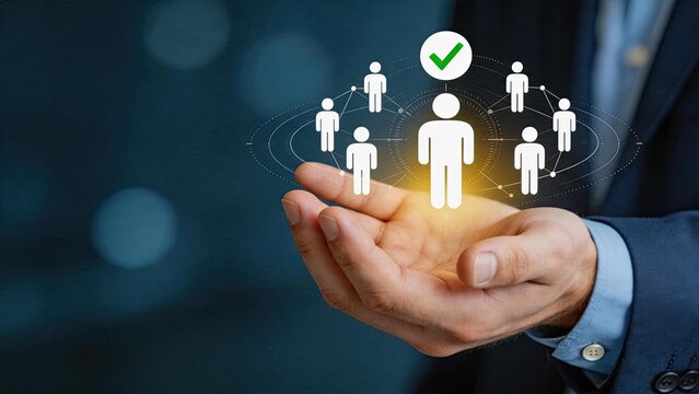 Hand holding holographic network of people icons with checkmark, representing team management, human resources selection, recruitment success, and social connection business