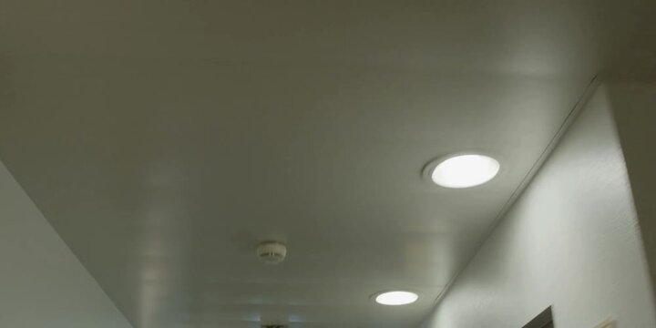 Modern Corridor With Recessed Ceiling Lights And Smoke Detector