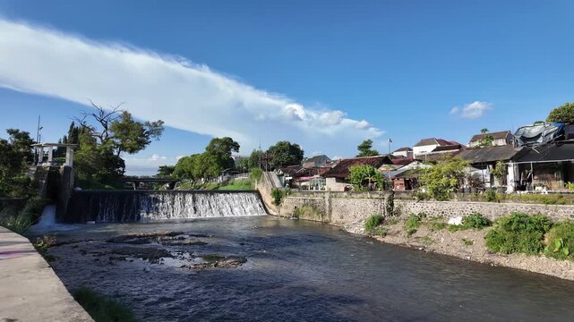 urban canal flowing through residential neighborhood in Yogyakarta