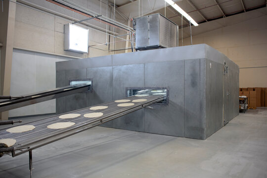 Tortillas moving on conveyor belts in a food factory