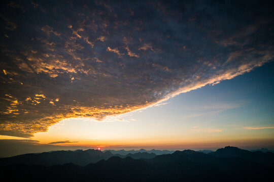 Stunning mountain sunrise with a dramatic cloud bank