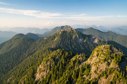 Golden sunlight on rolling forested mountains