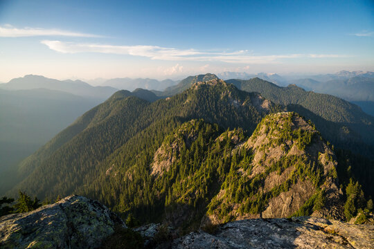 Golden hour light over lush green mountain peaks