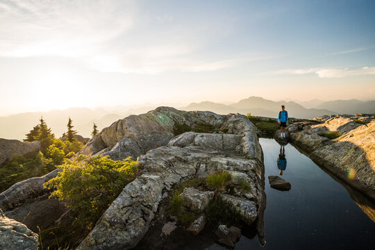 Young boy standing on a beautiful mountain summit