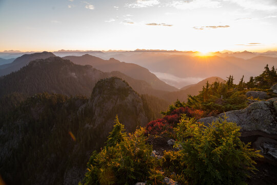 Golden sunrise over hazy mountain range and valleys