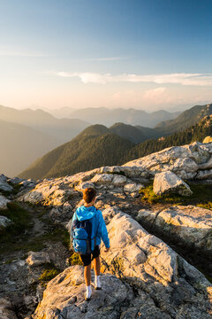 Young hiker watching the sunset over mountains