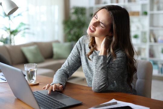 Teleworker working at home and suffering neck ache