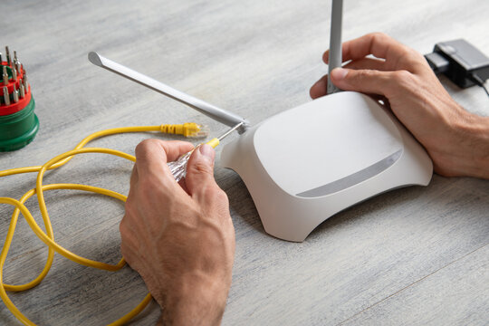 Caucasian man repairing wifi router. Internet. Technology
