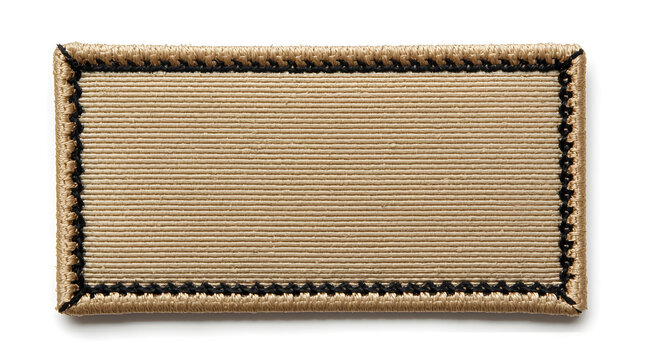 rectangular fabric patch with a natural beige color, resembling a canvas texture. The patch is bordered by a zigzag stitch in black thread, creating a contrasting