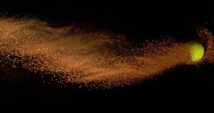 Super Slow Motion Tennis Ball in Flight with Clay Dust Explosion. Isolated on Black Background, 1000fps Ultra Slow Motion, Dynamic Sports Visual in Studio.