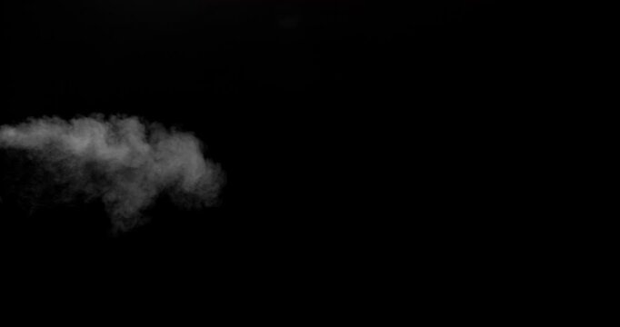 Realistic cold breath vapor drifting through dark air in slow motion. Frozen exhalation smoke effect isolated on black background, ideal for winter scenes, overlays, VFX compositing and cinematic effe