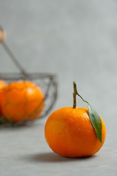 Fresh baby santang orange, or Citrus sinensis or jeruk santang on a minimal gray background.