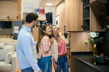 Naklejka premium People shopping for kitchen cabinets and furniture