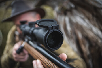 Fototapeta premium Rifle scope with protective lens cap in focus