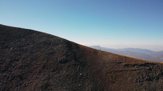 Aerial drone footage of a hiker climbing a steep mountain trail on the Continental Divide Trail, surrounded by rugged alpine terrain and expansive wilderness views.