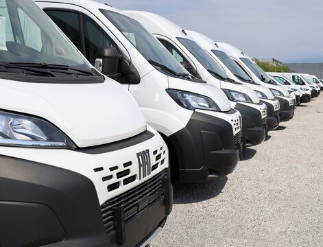 Tavagnacco, Italy. June 14, 2026. Row of white vans Fiat Ducato by the dealership. Side view.
