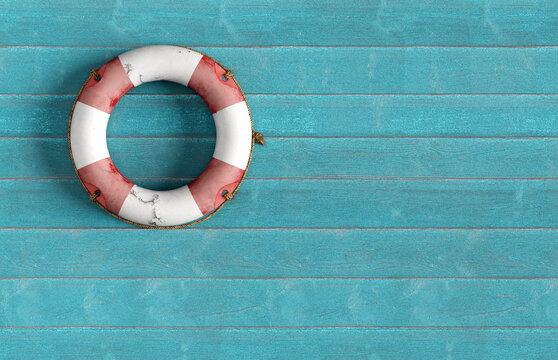 Lifebuoy hanging on blue wooden wall offering safety