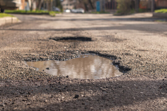 The terrible condition of the asphalt road in the suburbs