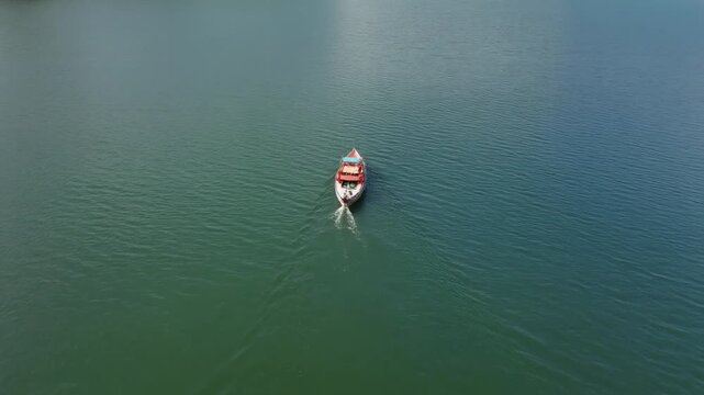 Tuyen Lam Lake aerial view of a boat cruising on calm water