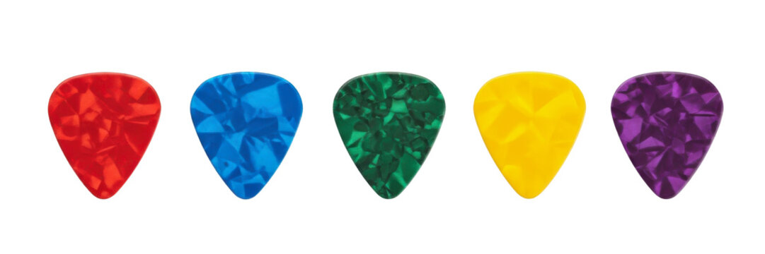 Row of five pearloid guitar picks in vibrant red blue green yellow and purple isolated on transparent background.