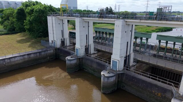 Wide aerial perspective of the Tail Sluice relief channel water management infrastructure in King's Lynn, Norfolk.
