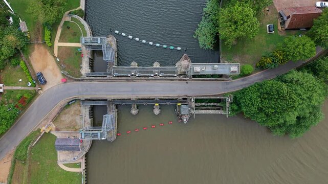 Top down aerial view of hydraulic sluice gate control system for river flood protection