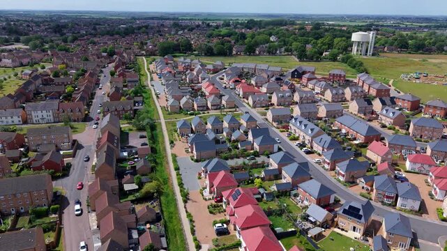Aerial view contrasting modern new build housing development alongside established old residential estate in Ely Cambridgeshire UK