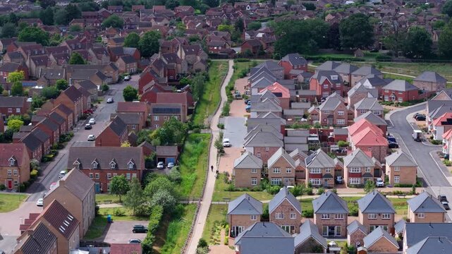 Aerial view contrasting modern new build housing development alongside established old residential estate in Ely Cambridgeshire UK