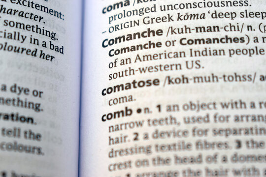 Close Up English Dictionary Page With The Word Translation Of - comanche