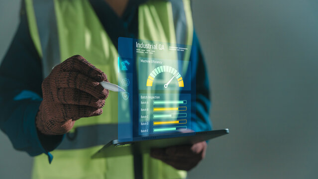 QA quality assurance industrial inspection concept worker using stylus on tablet with holographic machine efficiency gauge and batch testing dashboard