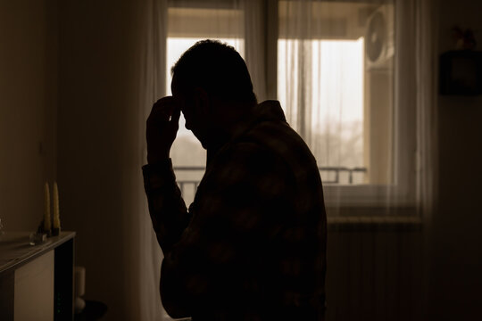 Man with headache, depression, sadness and loneliness at home